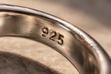 
  Macro photograph of a 925 stamp on sterling silver
