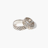 Two silver rings with intricate designs on a white background